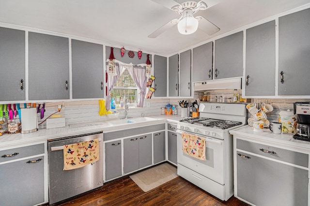 19030 W Almy Rd, Howard City, MI 49329 - kitchen with dishwasher, under cabinet range hood, white range with gas stovetop, gray cabinetry, and a sink