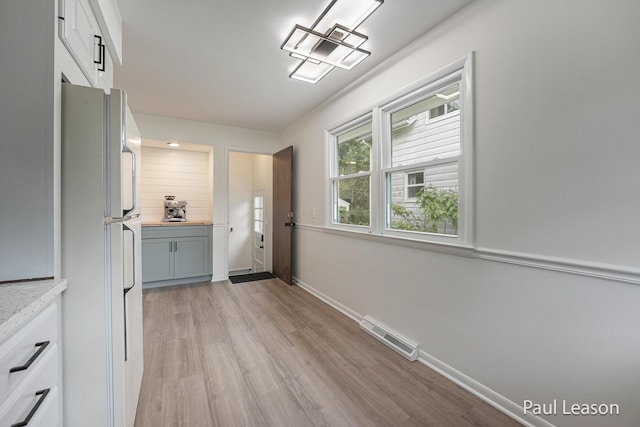 1043 Eastern Ave NE, Grand Rapids, MI 49503 - doorway to outside featuring light wood-style flooring and baseboards