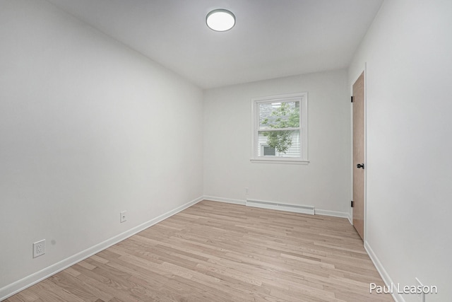 1043 Eastern Ave NE, Grand Rapids, MI 49503 - unfurnished room with a baseboard radiator, light wood finished floors, and baseboards