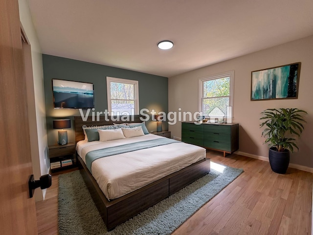 1043 Eastern Ave NE, Grand Rapids, MI 49503 - bedroom with multiple windows, light wood-type flooring, and baseboards