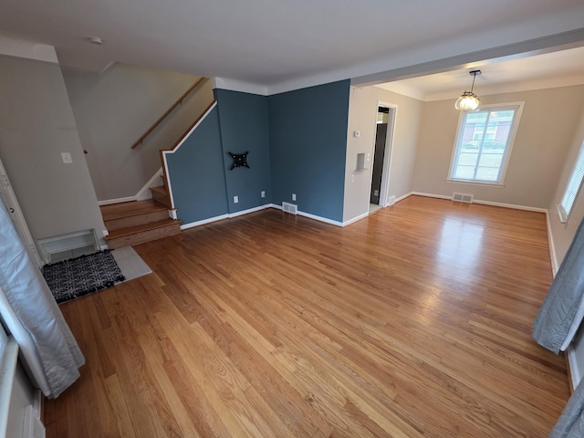1516 W Webster Rd, Royal Oak, MI 48073 - unfurnished living room with light wood finished floors, stairway, and baseboards