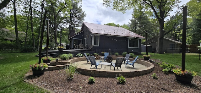 4447 Deer Creek Dr, Norton Shores, MI 49441 - back of property featuring a patio area, metal roof, and a chimney