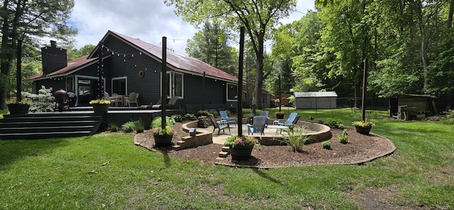 4447 Deer Creek Dr, Norton Shores, MI 49441 - back of property featuring a chimney, a patio area, a deck, a lawn, and metal roof
