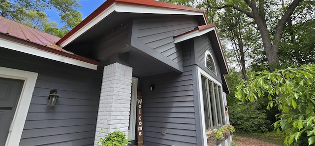 4447 Deer Creek Dr, Norton Shores, MI 49441 - view of side of home featuring metal roof