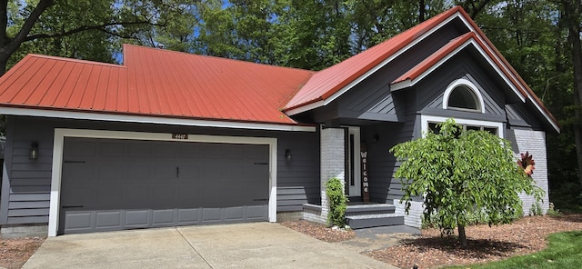 4447 Deer Creek Dr, Norton Shores, MI 49441 - view of front of house featuring metal roof and an attached garage