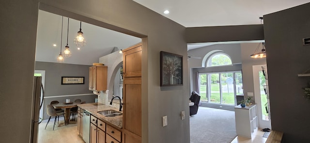 4447 Deer Creek Dr, Norton Shores, MI 49441 - kitchen featuring a sink, stainless steel dishwasher, freestanding refrigerator, light stone countertops, and pendant lighting