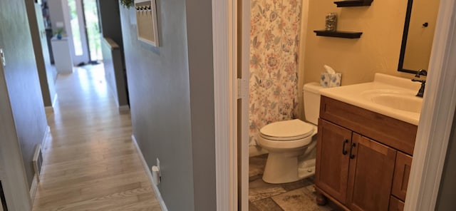 4447 Deer Creek Dr, Norton Shores, MI 49441 - bathroom with vanity, toilet, a shower with shower curtain, baseboards, and wood finished floors