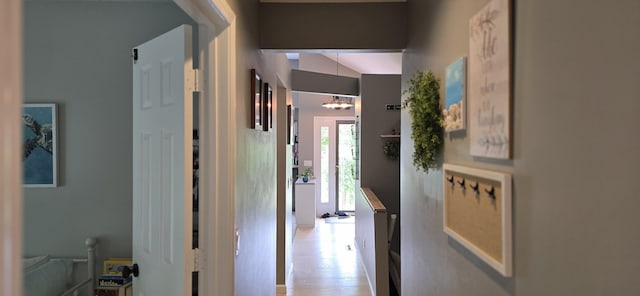 4447 Deer Creek Dr, Norton Shores, MI 49441 - corridor with a chandelier and wood finished floors