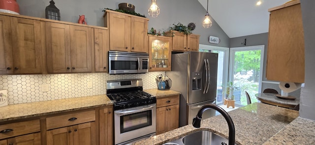 4447 Deer Creek Dr, Norton Shores, MI 49441 - kitchen featuring stainless steel appliances, tasteful backsplash, lofted ceiling, decorative light fixtures, and glass insert cabinets
