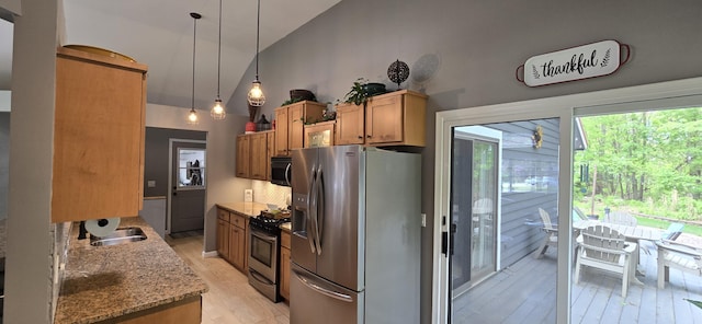 4447 Deer Creek Dr, Norton Shores, MI 49441 - kitchen featuring stainless steel appliances, high vaulted ceiling, light wood-style floors, a sink, and light stone countertops