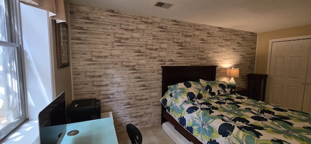 4447 Deer Creek Dr, Norton Shores, MI 49441 - carpeted bedroom featuring wooden walls and a closet