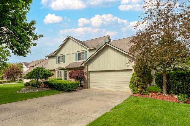 24609 Redwing Dr, Novi, MI 48374 - view of front of house with a garage, concrete driveway, a front yard, roof with shingles, and brick siding