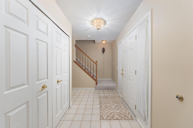 24609 Redwing Dr, Novi, MI 48374 - entryway with light tile patterned flooring, stairway, and baseboards