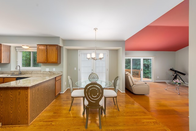 24609 Redwing Dr, Novi, MI 48374 - dining space with a chandelier, light wood-style floors, and baseboards