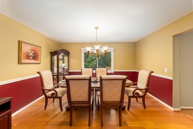 24609 Redwing Dr, Novi, MI 48374 - dining space featuring a chandelier, light wood-type flooring, and baseboards