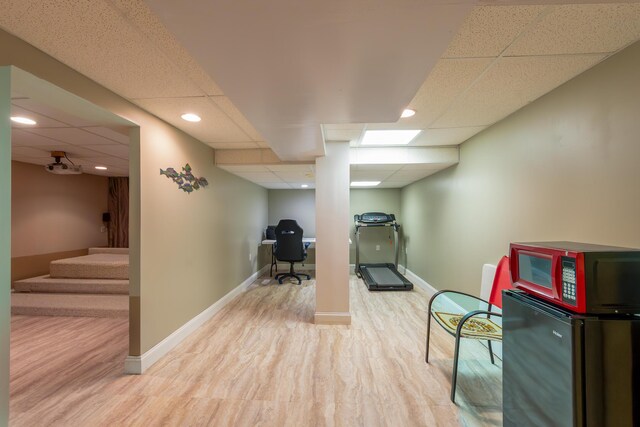 24609 Redwing Dr, Novi, MI 48374 - workout area with a paneled ceiling, wood finished floors, and baseboards