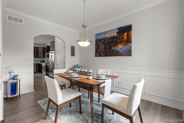 52690 Char Marie, Macomb, MI 48042 - dining room with arched walkways, ornamental molding, wood finished floors, wainscoting, and a decorative wall