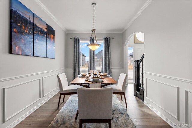 52690 Char Marie, Macomb, MI 48042 - dining area with wood finished floors, arched walkways, crown molding, a decorative wall, and wainscoting