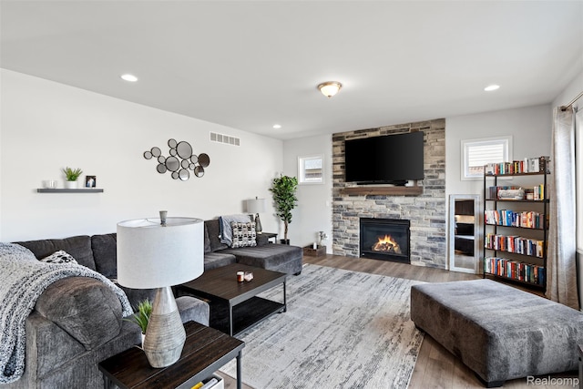 52690 Char Marie, Macomb, MI 48042 - living area with plenty of natural light, wood finished floors, a stone fireplace, and recessed lighting