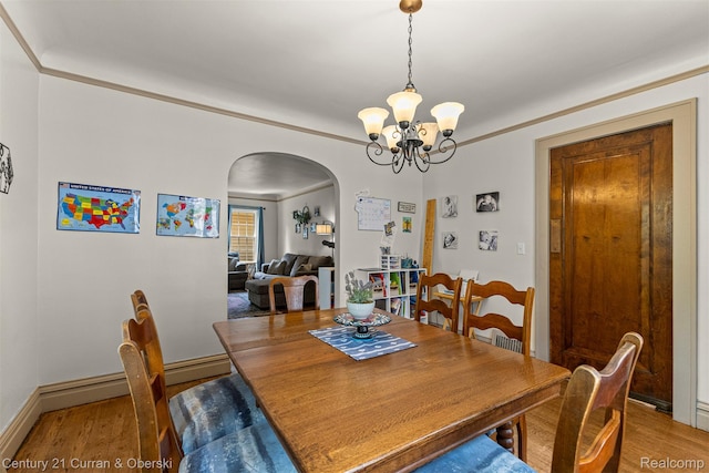 34642 Elm St, Wayne, MI 48184 - dining room with arched walkways, a chandelier, and light wood-style flooring