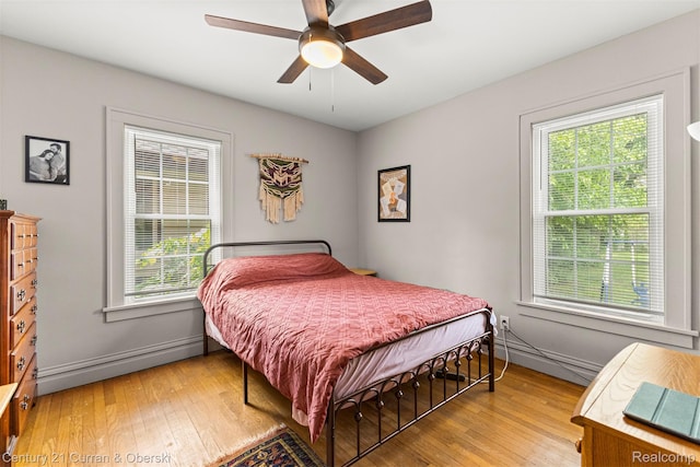 34642 Elm St, Wayne, MI 48184 - bedroom with multiple windows, light wood finished floors, and baseboard heating