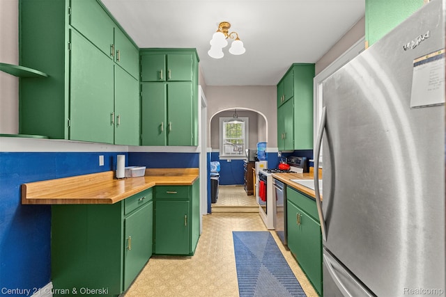 34642 Elm St, Wayne, MI 48184 - kitchen with freestanding refrigerator, light floors, gas range gas stove, open shelves, and wood counters