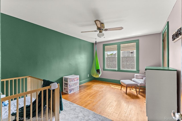 34642 Elm St, Wayne, MI 48184 - bedroom with wood finished floors, a nursery area, and ceiling fan