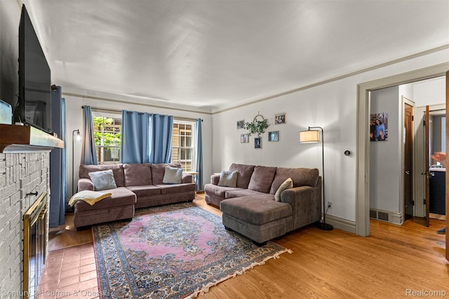 34642 Elm St, Wayne, MI 48184 - living room with a brick fireplace and light wood finished floors