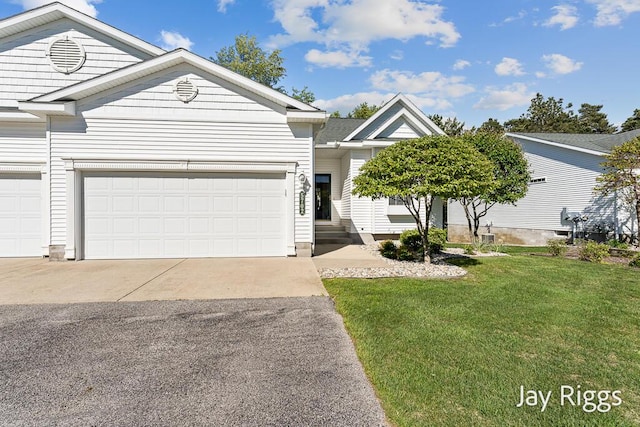 5702 Copper Sands Run Unit 101, Fruitport, MI 49415 - ranch-style home with driveway, a front lawn, and an attached garage