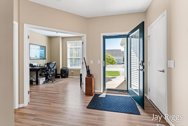 5702 Copper Sands Run Unit 101, Fruitport, MI 49415 - entryway with light wood-style flooring and baseboards