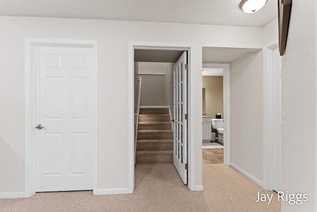 5702 Copper Sands Run Unit 101, Fruitport, MI 49415 - hall featuring light carpet, baseboards, and stairs