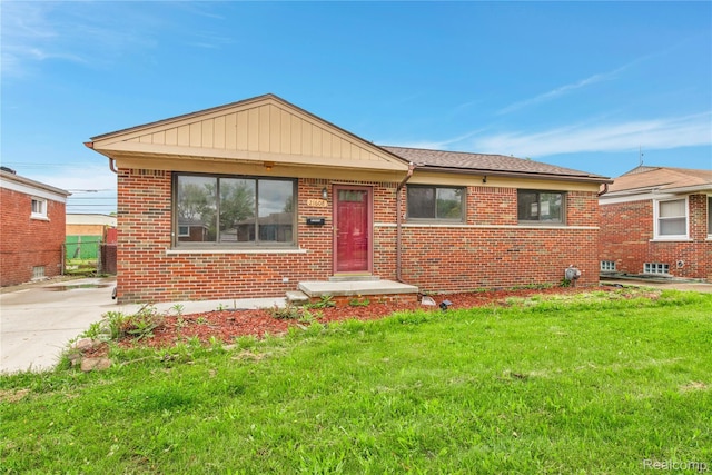 21608 Barton St, Saint Clair Shores, MI 48081 - bungalow-style home with a front yard and brick siding