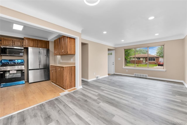 21608 Barton St, Saint Clair Shores, MI 48081 - kitchen featuring stainless steel appliances, light wood-type flooring, brown cabinetry, light countertops, and recessed lighting
