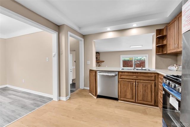 21608 Barton St, Saint Clair Shores, MI 48081 - kitchen featuring appliances with stainless steel finishes, a sink, light wood finished floors, recessed lighting, and brown cabinetry