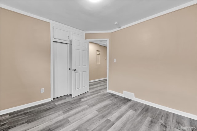 21608 Barton St, Saint Clair Shores, MI 48081 - unfurnished bedroom with light wood-style flooring, baseboards, and a closet