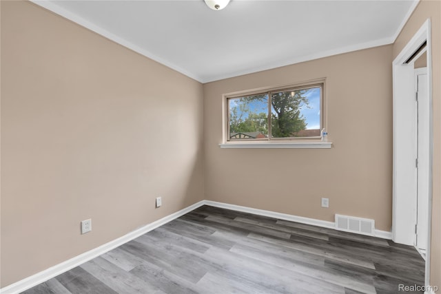 21608 Barton St, Saint Clair Shores, MI 48081 - unfurnished bedroom with wood finished floors, baseboards, and ornamental molding