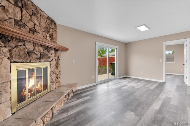 21608 Barton St, Saint Clair Shores, MI 48081 - unfurnished living room with a fireplace, wood finished floors, and baseboards