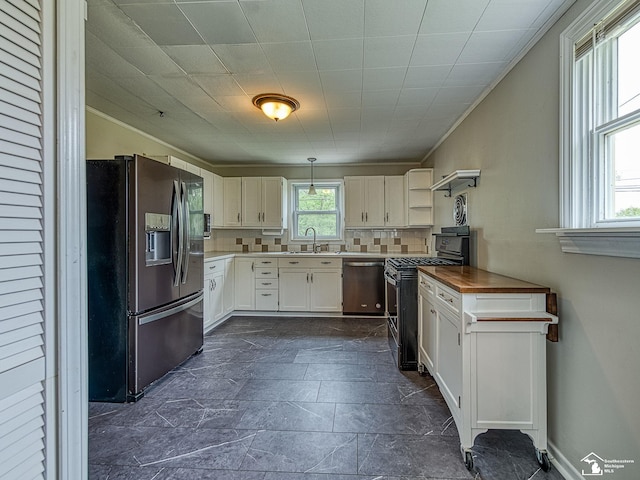 22933 Monterey Dr, Woodhaven, MI 48183 - kitchen featuring stainless steel appliances, decorative backsplash, ornamental molding, a sink, and white cabinetry