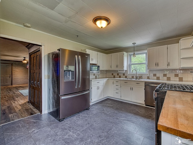 22933 Monterey Dr, Woodhaven, MI 48183 - kitchen with appliances with stainless steel finishes, a sink, open shelves, white cabinets, and light countertops