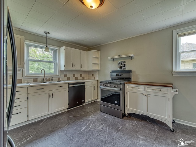 22933 Monterey Dr, Woodhaven, MI 48183 - kitchen with dishwasher, stainless steel range with gas stovetop, a sink, and plenty of natural light