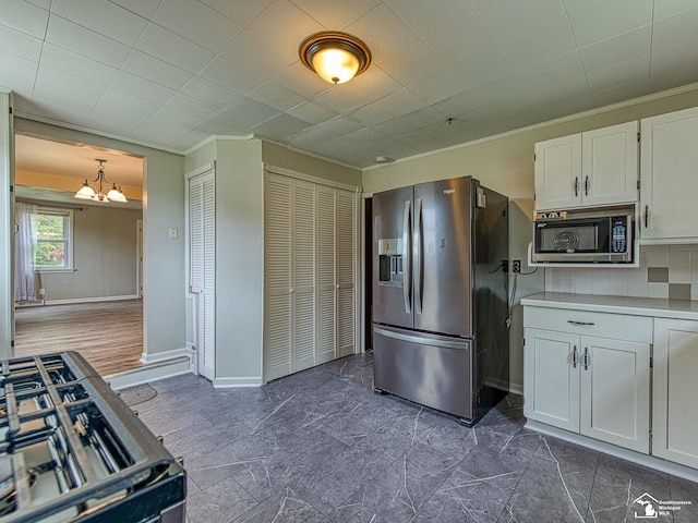 22933 Monterey Dr, Woodhaven, MI 48183 - kitchen featuring stainless steel refrigerator with ice dispenser, a chandelier, white cabinets, gas range, and light countertops
