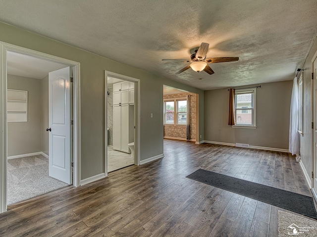 22933 Monterey Dr, Woodhaven, MI 48183 - unfurnished room featuring a ceiling fan, dark wood-style floors, a textured ceiling, and baseboards
