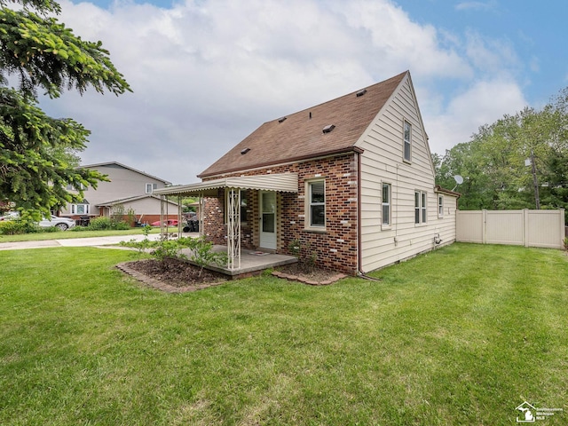 22933 Monterey Dr, Woodhaven, MI 48183 - back of property with brick siding, a patio area, and a shingled roof