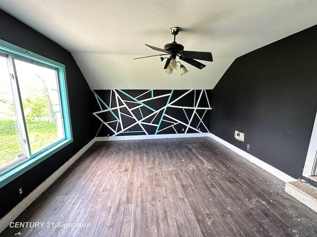 5207 S Whiteville Rd, Mount Pleasant, MI 48858 - empty room featuring lofted ceiling, wood finished floors, baseboards, a textured ceiling, and ceiling fan