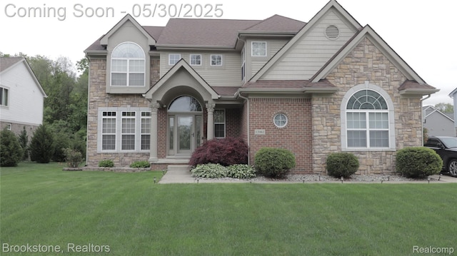 13961 Cobblestone Creek Dr, Belleville, MI 48111 - view of front facade featuring a front yard, stone siding, and a shingled roof