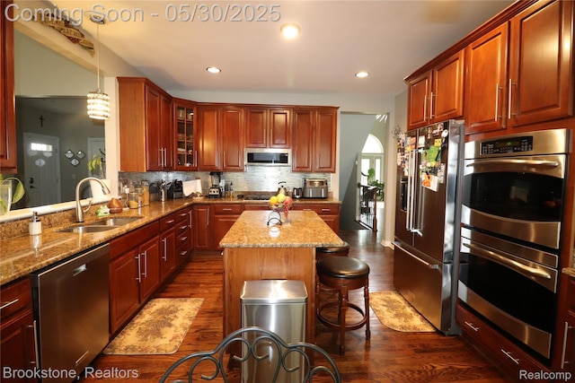 13961 Cobblestone Creek Dr, Belleville, MI 48111 - kitchen featuring appliances with stainless steel finishes, a sink, dark wood-style flooring, light stone countertops, and recessed lighting