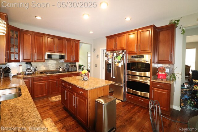 13961 Cobblestone Creek Dr, Belleville, MI 48111 - kitchen with appliances with stainless steel finishes, decorative backsplash, dark wood-type flooring, glass insert cabinets, and recessed lighting