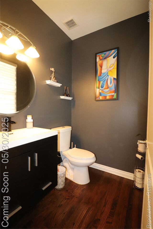 13961 Cobblestone Creek Dr, Belleville, MI 48111 - bathroom featuring wood finished floors, vanity, toilet, and baseboards