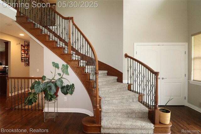 13961 Cobblestone Creek Dr, Belleville, MI 48111 - staircase with wood finished floors, baseboards, and a high ceiling