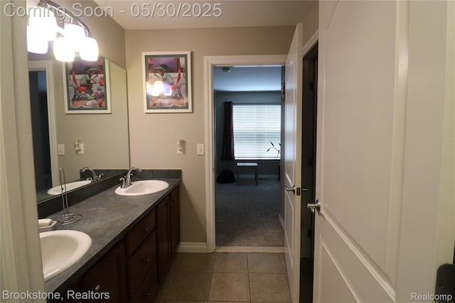 13961 Cobblestone Creek Dr, Belleville, MI 48111 - bathroom featuring double vanity, tile patterned flooring, and baseboards